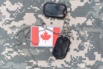 army blank, dog tag with flag of canada on the khaki texture background. military concept