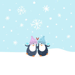 A pair of cute penguins each holding a small gift in their hands and wearing woolen hats with Christmas patterns hugging each other on the snow with large and small snowflakes falling on the blue sky,