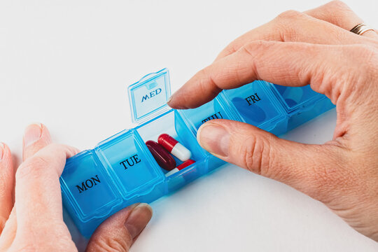 plastic organizer pill box for the week blue color isolated on a white background.