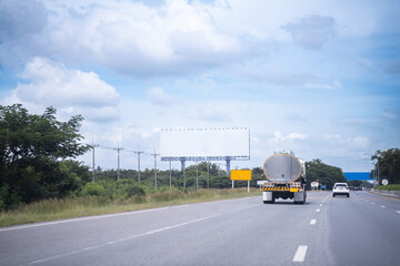 Big oil tanker truck on the road to transport flammable materials. bright sky background