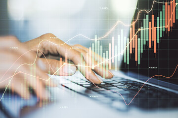 Double exposure of abstract creative financial chart with hand typing on computer keyboard on background, research and strategy concept