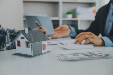 Fototapeta premium Real estate agent and customer signing contract to buy house, insurance or loan real estate.rent a house,get insurance or loan real estate or property.