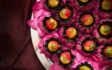 Obraz na płótnie Canvas Thai traditional dessert concept, Assorted Thai desserts served on pink lotus flower for auspicious day.