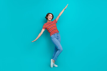 Fototapeta na wymiar Full length photo of good mood cheerful girl wear stylish clothes open hands have fun fly air isolated on cyan color background