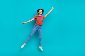 Full length photo of positive cute girl dressed stylish clothes hold billboard empty space isolated on cyan color background