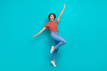 Fototapeta na wymiar Full length photo of positive cheerful glad woman dressed stylish clothes raise hands celebrate holiday isolated on cyan color background