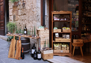Naklejka premium A shop selling local and typical italian produce in the historic center of Massa Maritima. Tuscany.