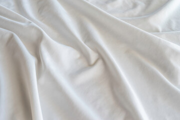 White silk fabric background. Crumpled fabric texture.