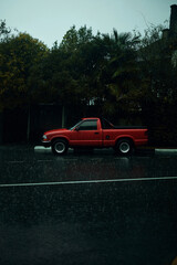 red pickup truck in the rain