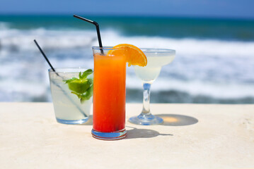 Cocktail glasses on sea background