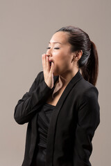 Chinese woman looking tired and Yawning