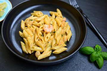  Italian home made   pennette pasta with smoked salmon , creamy sauce and fresh dill on wooden background