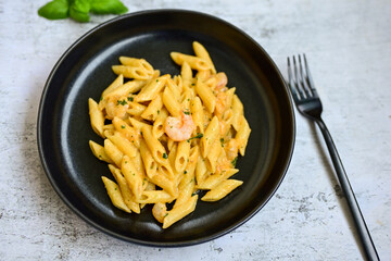  Italian home made   pennette pasta with smoked salmon , creamy sauce and fresh dill on wooden background