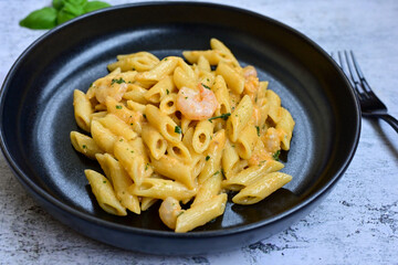  Italian home made   pennette pasta with smoked salmon , creamy sauce and fresh dill on wooden background