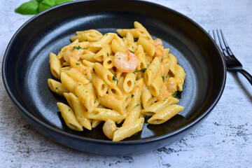  Italian home made   pennette pasta with smoked salmon , creamy sauce and fresh dill on wooden background