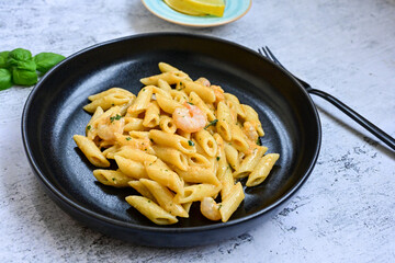  Italian home made   pennette pasta with smoked salmon , creamy sauce and fresh dill on wooden background