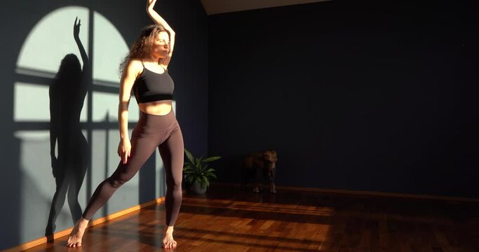 Curly girl dances contemporary in the studio 