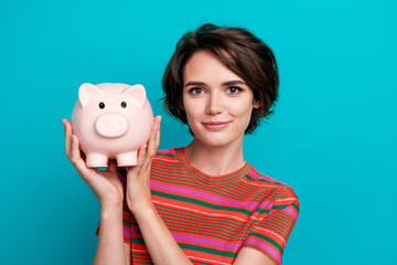Photo of adorable wealthy rich girl dressed striped stylish clothes hold piggy bank storage deposit...