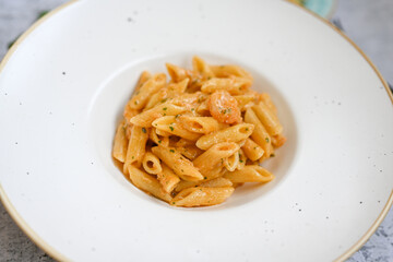  Italian home made   pennette pasta with smoked salmon , creamy sauce and fresh dill on wooden background