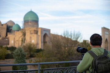 a man doing videography and I historical place in Samarkand