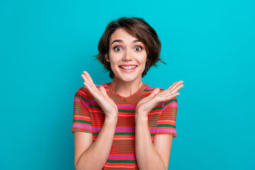 Portrait of overjoyed girl with short hair wear stylish t-shirt astonished staring hold palms near...