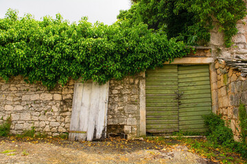 Fototapeta na wymiar An old gate in an historic residential building in the town of Nerezisca, Brac Island, Croatia