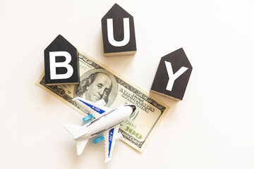 Wooden blocks with buy text of concept and airplanes.