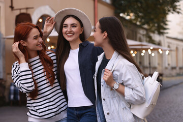 Happy friends spending time together on city street