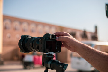 man shooting a photo with his camera and a historical place, Khiva, the Khoresm agricultural oasis,...