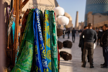 Fototapeta premium beautiful handmade clothes selling in the streets of historical place, Khiva, the Khoresm agricultural oasis, Citadel.