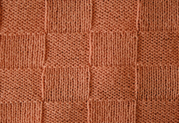 Unusual abstract knitted chess pattern background texture. Top view, close-up. Handmade knitting...