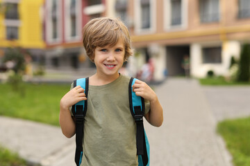 Cute little boy walking to kindergarten outdoors