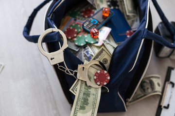 Handcuffs on many stacks of dollar bills. Metal suitcase with money, concept of arrest, investigation and fraud.