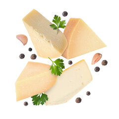 Different kinds of cheese, parsley, garlic and peppercorns falling on white background