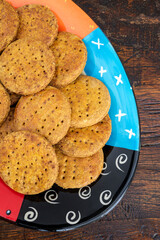Homemade cookies on a colorful plate and wooden table.