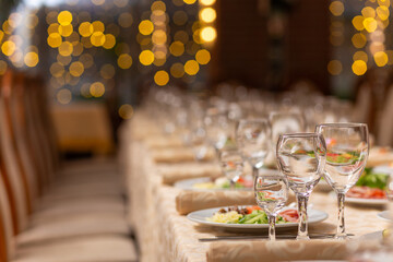 Served festive table with snacks, glasses, glasses, cutlery and napkins for a banquet