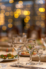 Served festive table with snacks, glasses, glasses, cutlery and napkins for a banquet