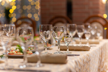 Served festive table with snacks, glasses, glasses, cutlery and napkins for a banquet