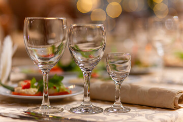 Served festive table with snacks, glasses, glasses, cutlery and napkins for a banquet