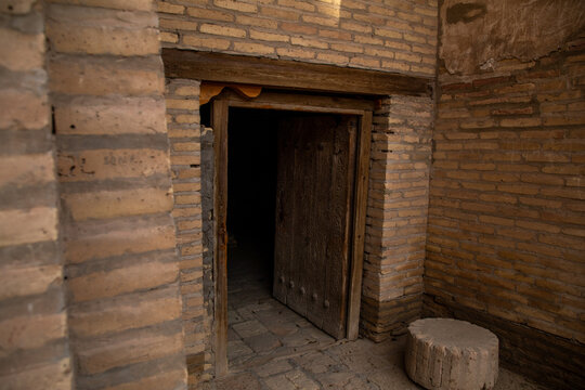 door opening into a dark room inside the historical building, Khiva, the Khoresm agricultural oasis, Citadel.