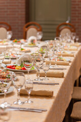 Served festive table with snacks, glasses, glasses, cutlery and napkins for a banquet