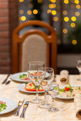 Served festive table with snacks, glasses, glasses, cutlery and napkins for a banquet