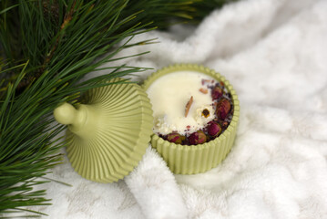 Handmade scented candle near Christmas tree