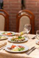 Served festive table with snacks, glasses, glasses, cutlery and napkins for a banquet
