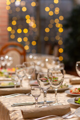 Served festive table with snacks, glasses, glasses, cutlery and napkins for a banquet