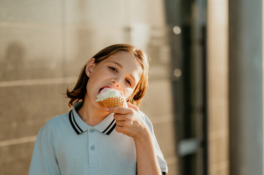Girl enjoying ice cream cone in sunlight