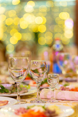 Served festive table with snacks, glasses, glasses, cutlery and napkins for a banquet