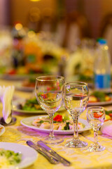 Served festive table with snacks, glasses, glasses, cutlery and napkins for a banquet