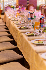 Served festive table with snacks, glasses, glasses, cutlery and napkins for a banquet