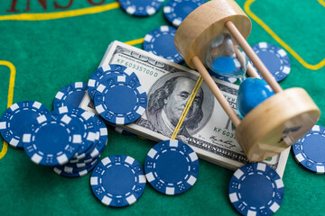 Poker playing chips with card and dollar banknoteson a casino green table. Online gambling. Texas